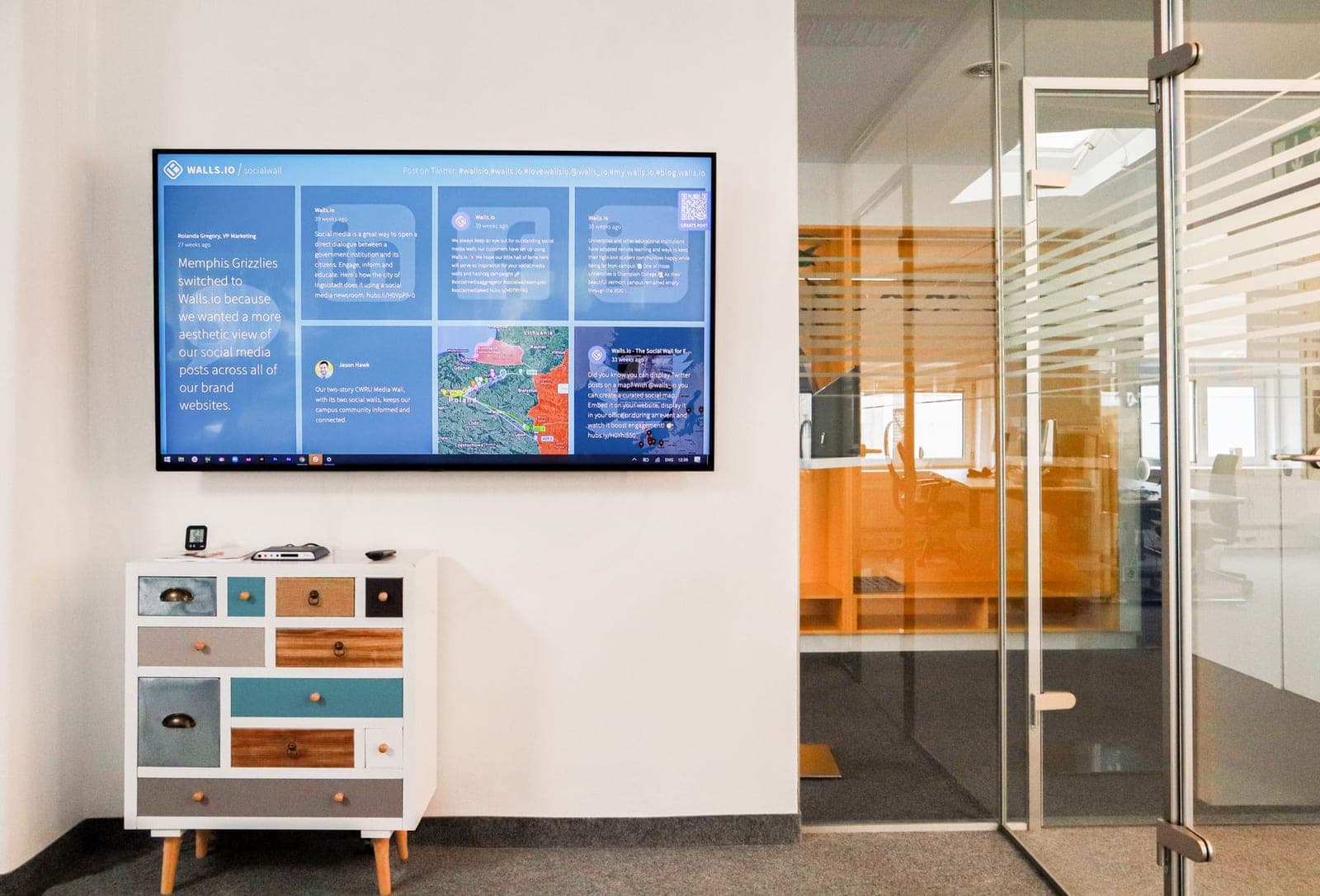A row of digital menu displays installed level across a restaurant wall