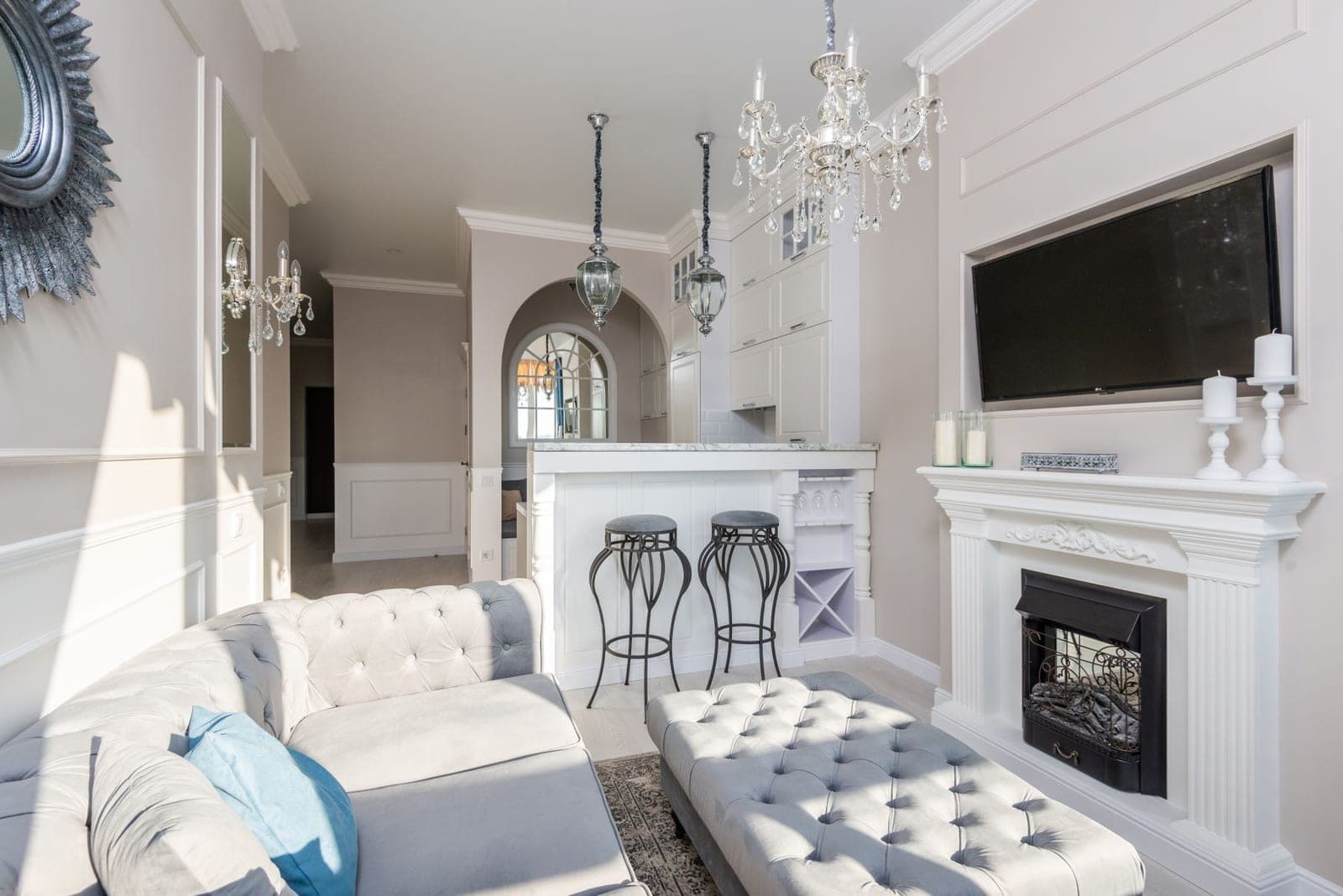 TV mounted over a stone fireplace between built-in shelves