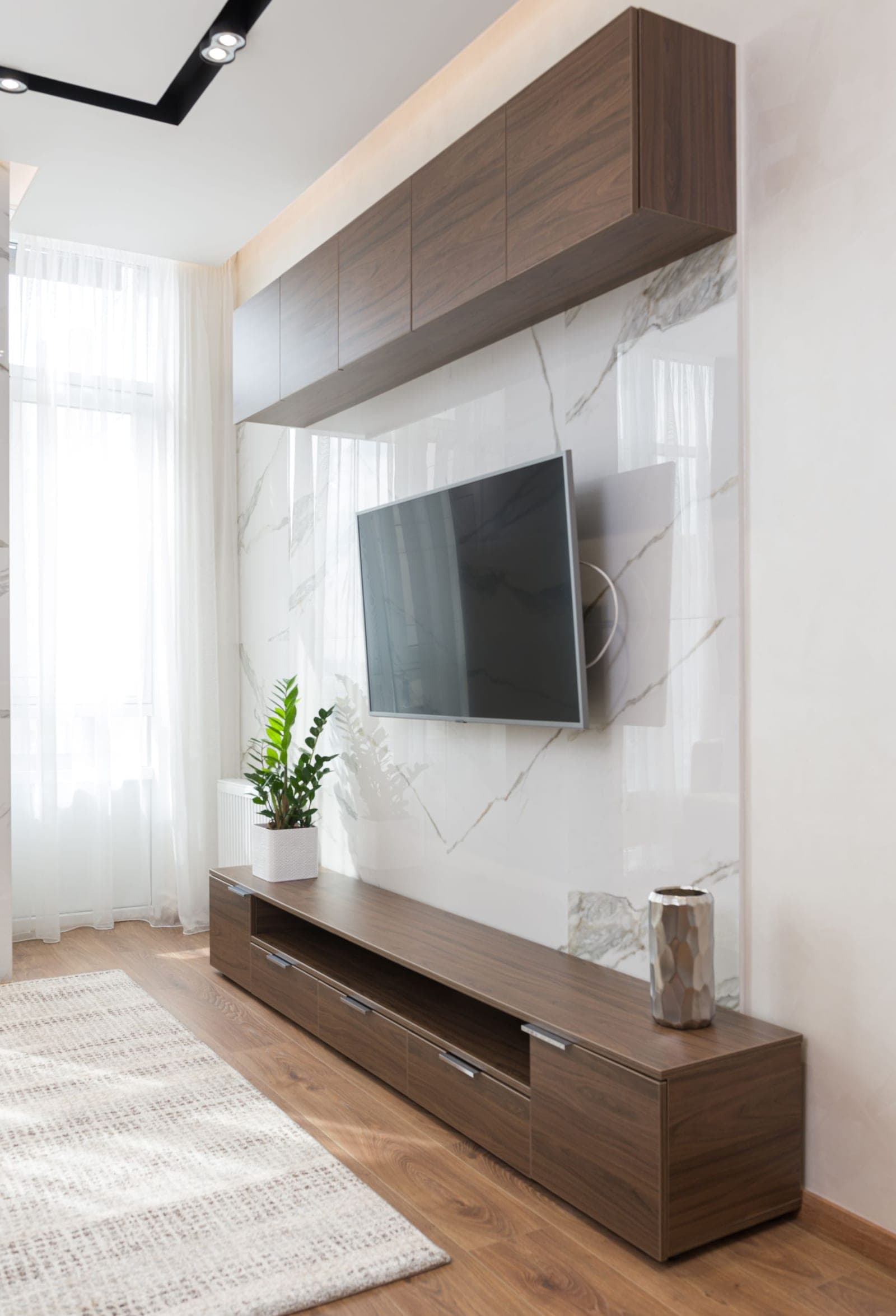 TV mounted above a tiled fireplace with a wood mantel