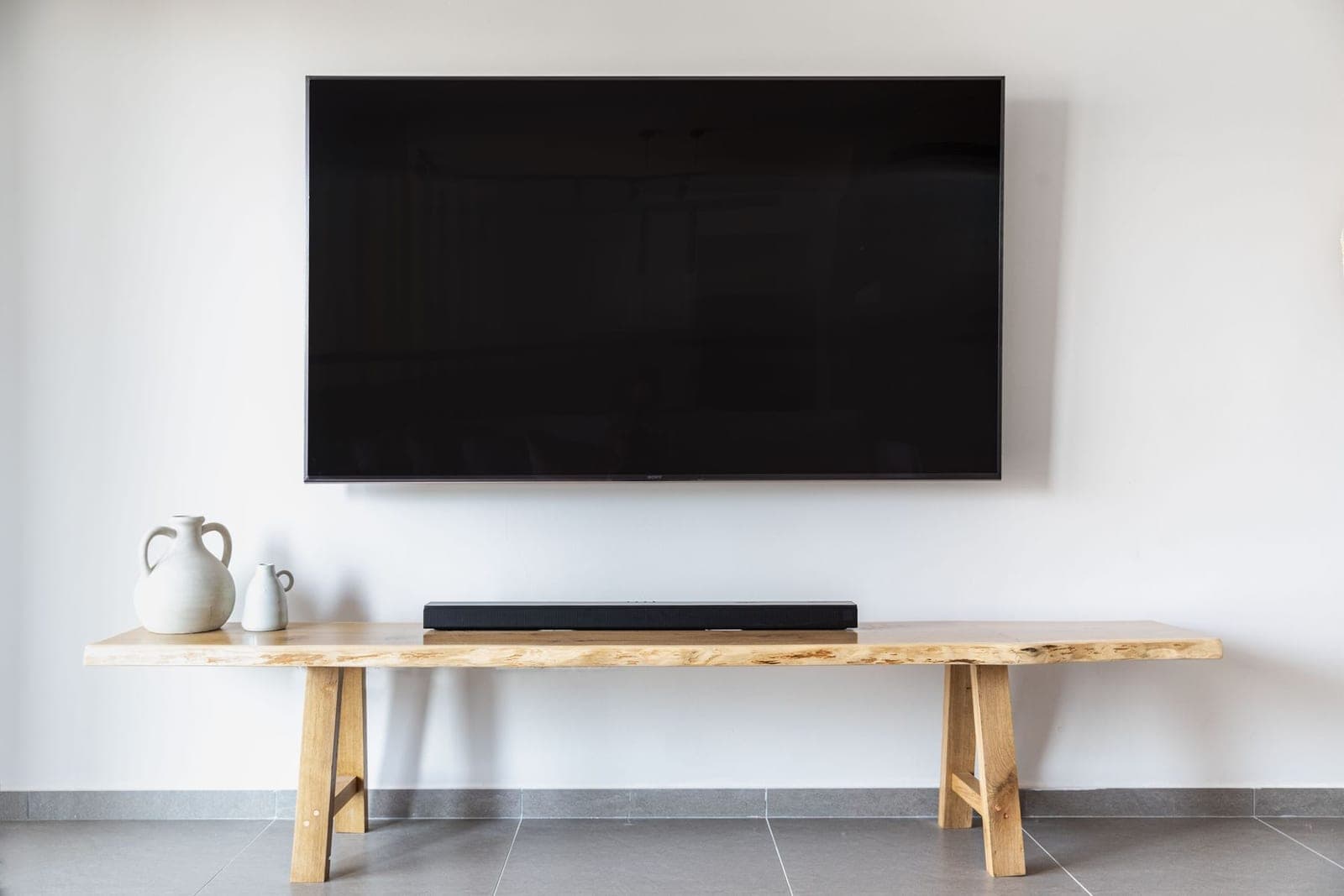 Large flat-screen TV mounted level on a living room wall with no visible wires