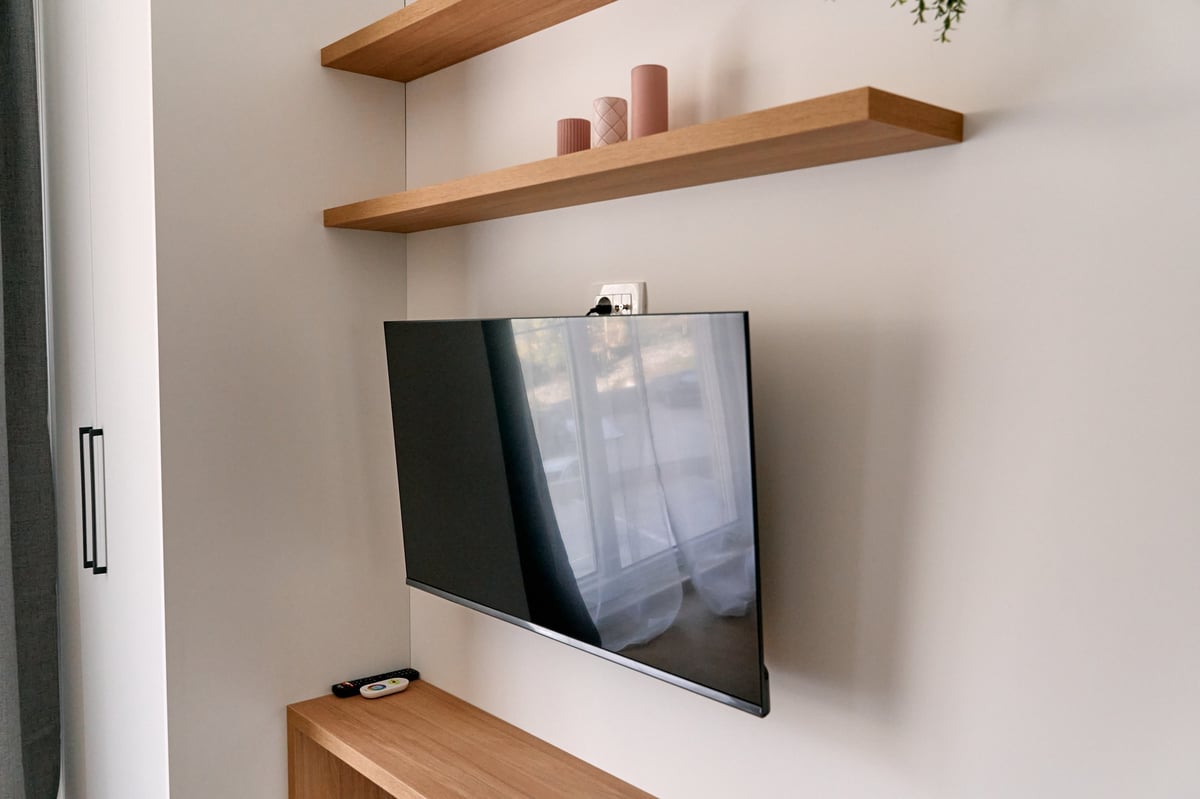 Wall-mounted flat-screen TV in a modern living room